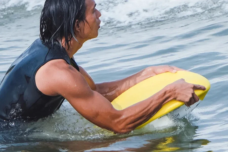 Professional athlete swimming using kickboard