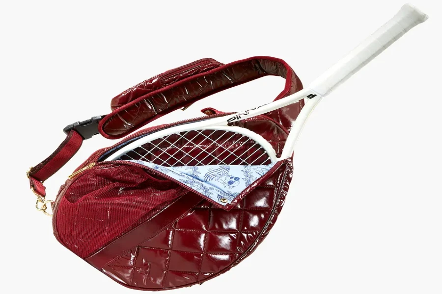 red leather sling tennis bag with white racket inside