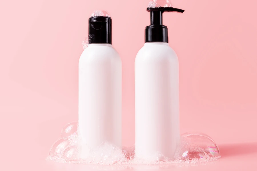 shampoo and conditioner on a pink background