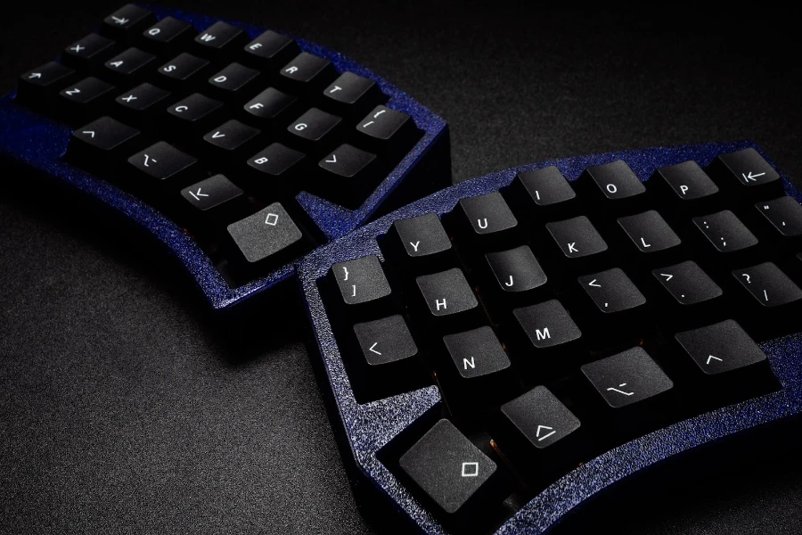 split black mechanical keyboard on a black background