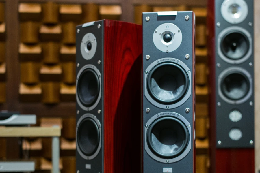 Three red and black powered speakers in a room