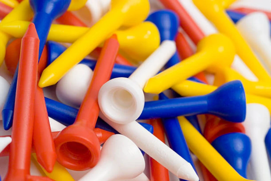 Various colors of plastic golf tees in a large pile