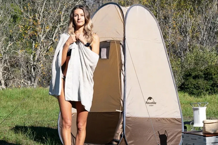 woman standing in front of brown pop up tent