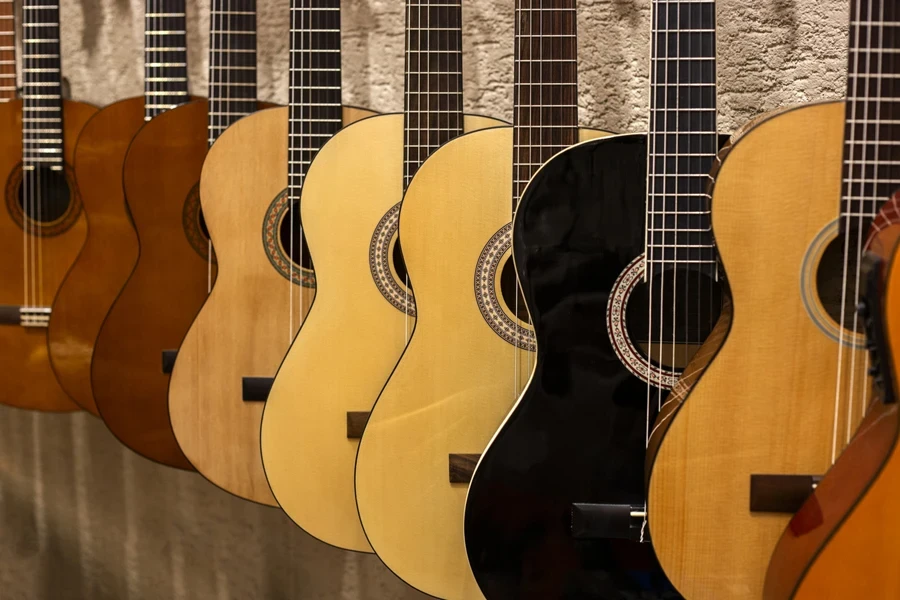 Row of classical guitars in different wood tones