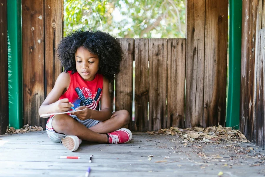 A child playing in a wooden playhouse