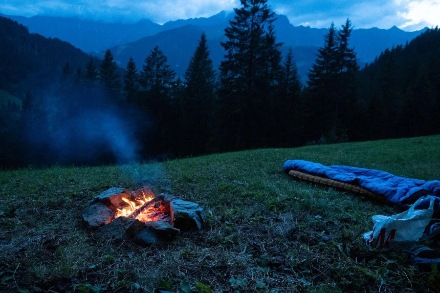 A cold-weather sleeping bag next to a fire