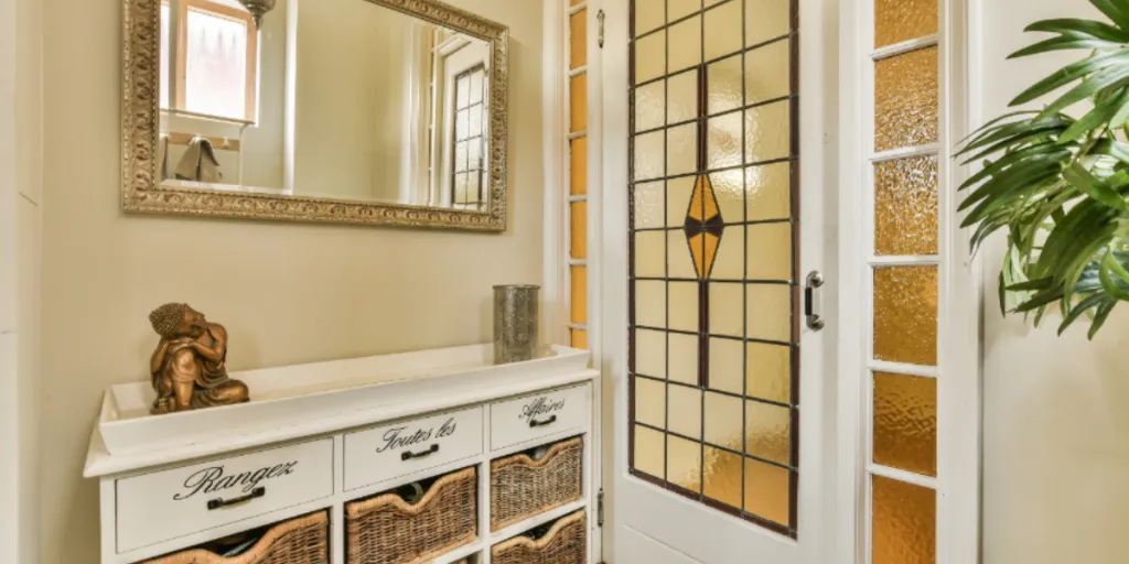 a console mirror and table in an entryway