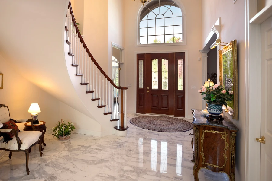 a grand entryway with marble floors and decor