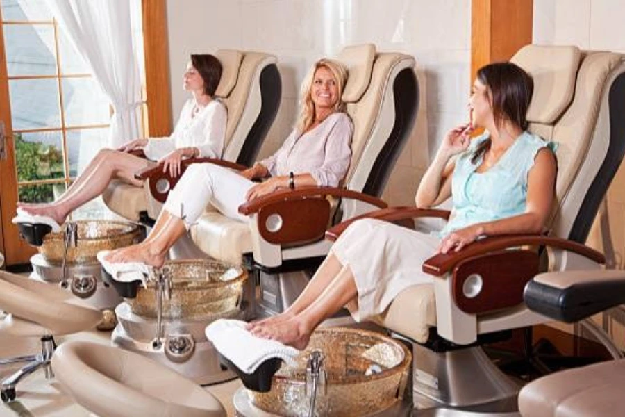 A group of women seated in pedicure chairs
