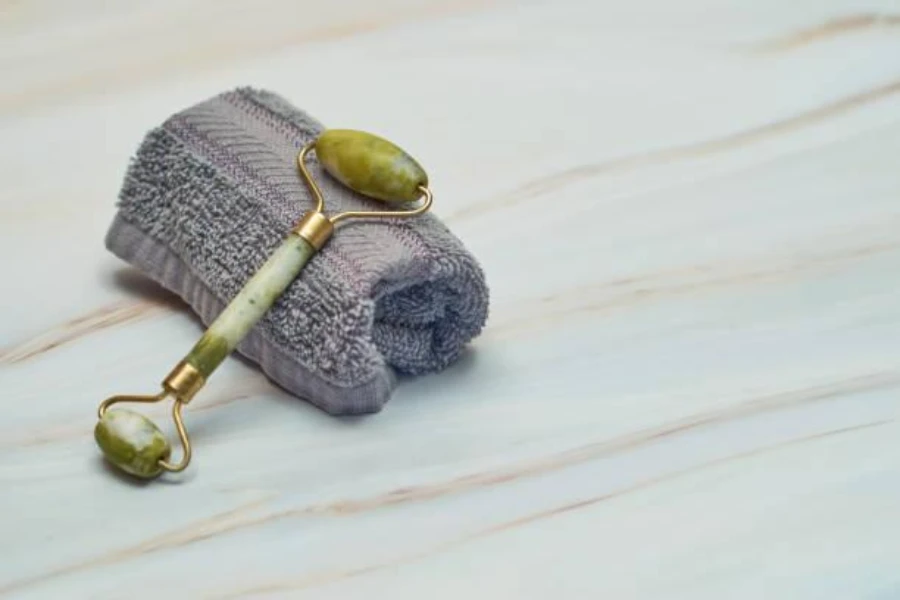 A jade roller placed on a rolled-up towel