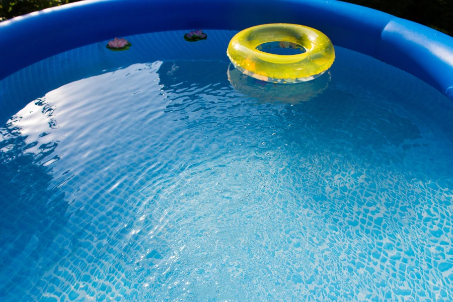 A large blue family pool with a rubber ring float