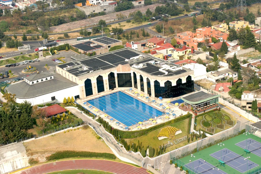 A large building with a pool and solar heater