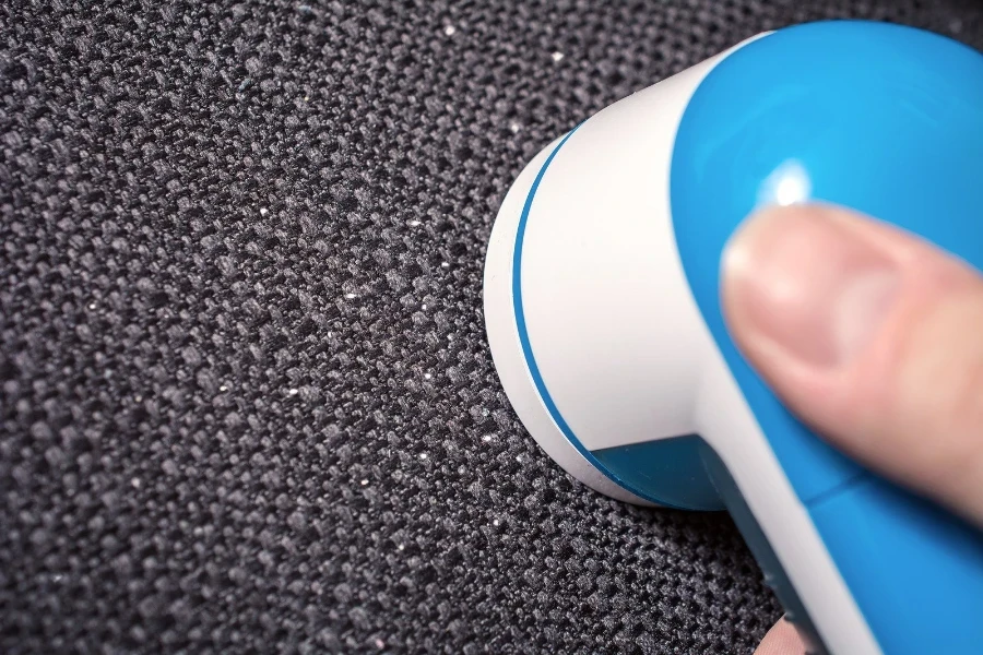 A lint remover collecting fuzz from a couch