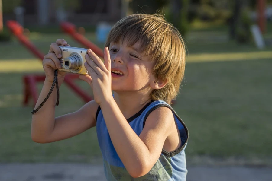 a little boy taking photos