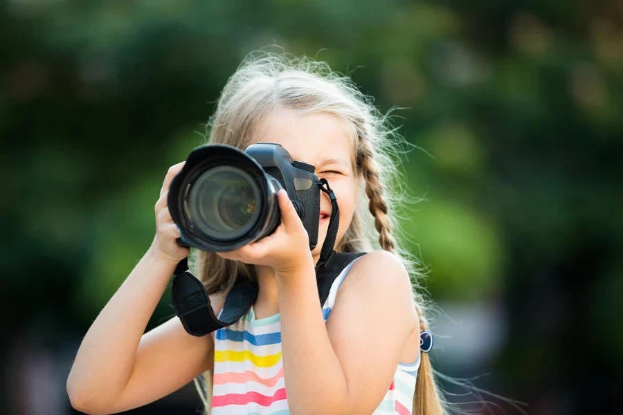 a little girl using a camera