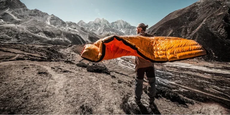 A man carrying a camping sleeping bag
