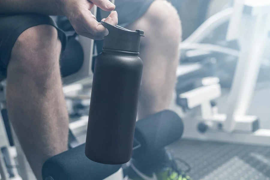 a man holding a stainless steel water bottle