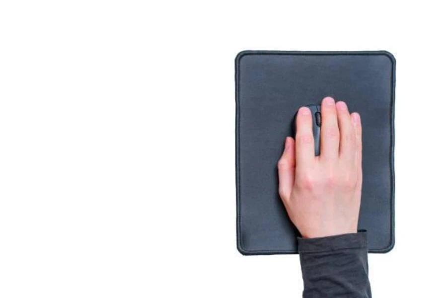 A man navigating a mouse on a soft mouse pad