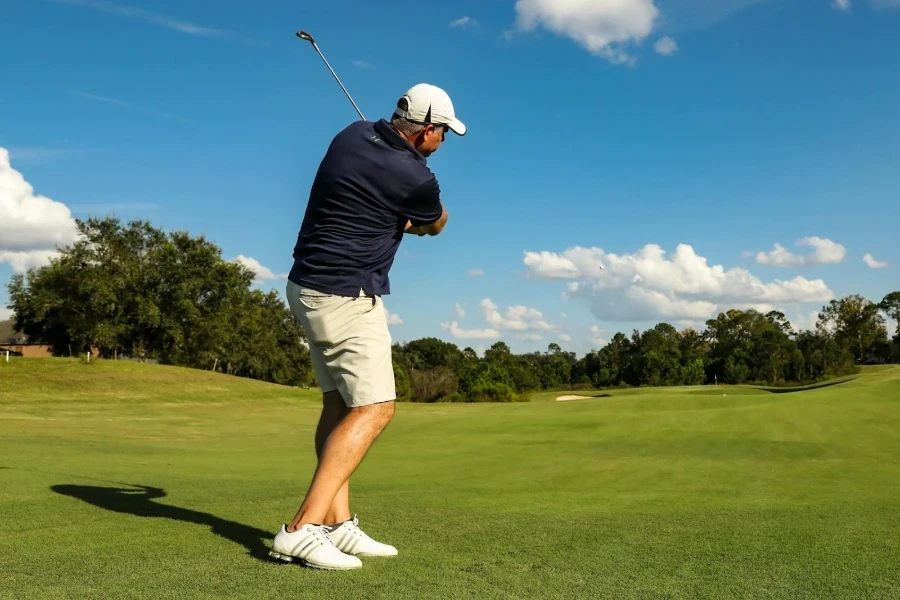 A man playing golf in high-tier golf shoes