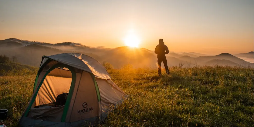 A man watching the sun rise during a camp