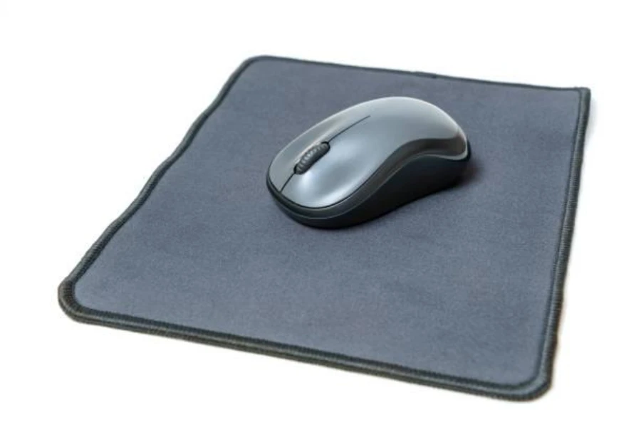 A mouse placed at the center of a mouse pad with stitched edgings