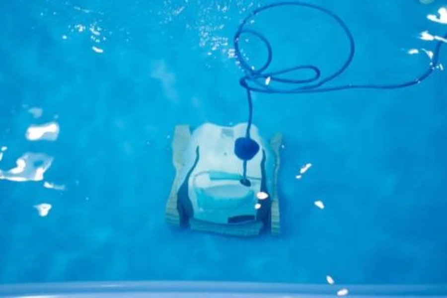 A robotic pool cleaner at the bottom of a pool