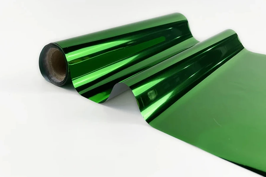 A roll of green metallic foil on a white background