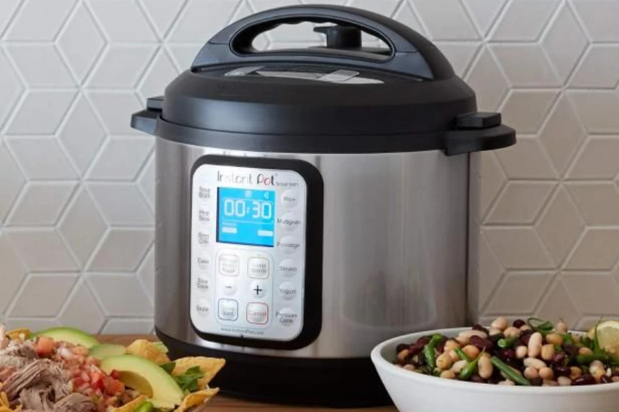 A smart pressure cooker with various foods around it