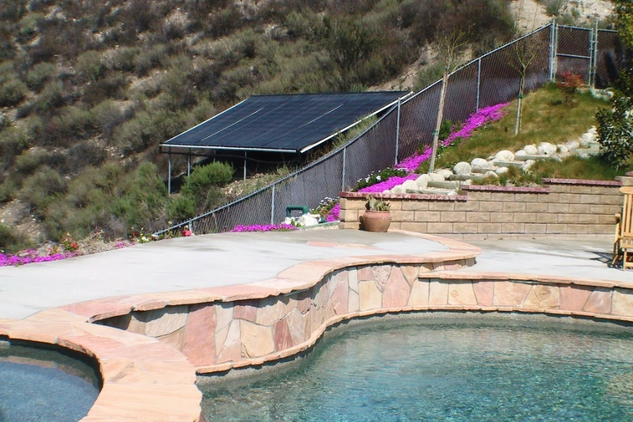 A solar panel heater near an outdoor pool