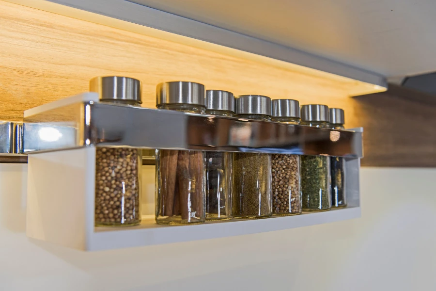 A wall mounted spice rack with different spices