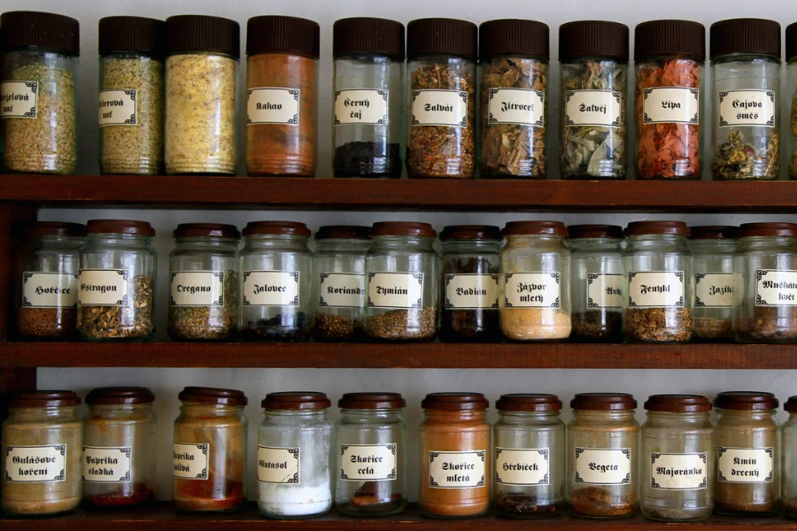 A well-labeled spice rack hung on a kitchen wall
