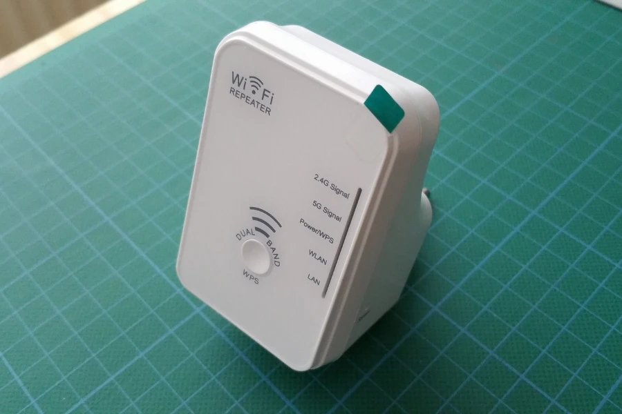 A white network repeater on a green surface