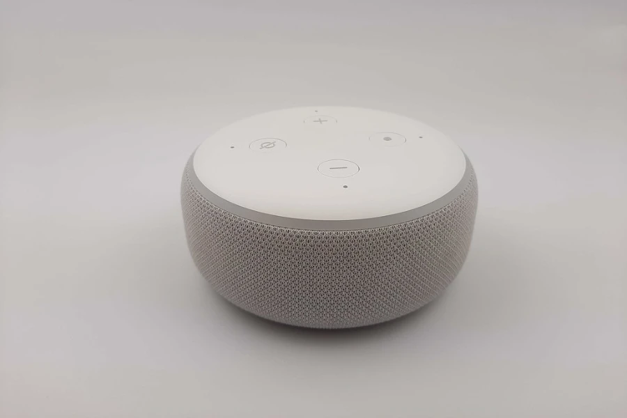 A white smart speaker on a light gray background