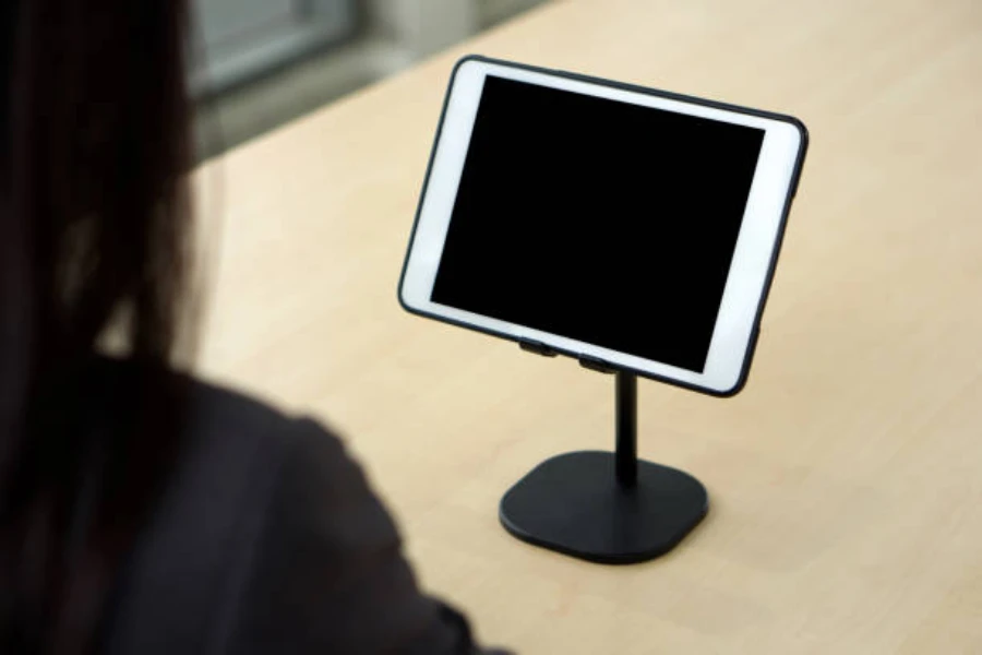 A white tablet on a black lifted stand