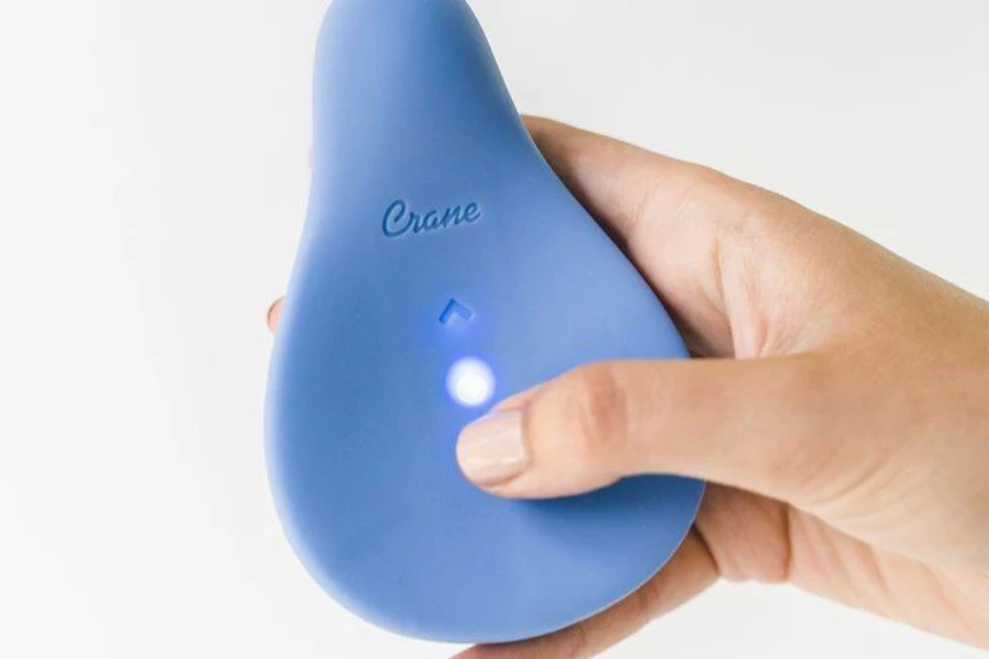 A woman holding a cooling relief breast massager