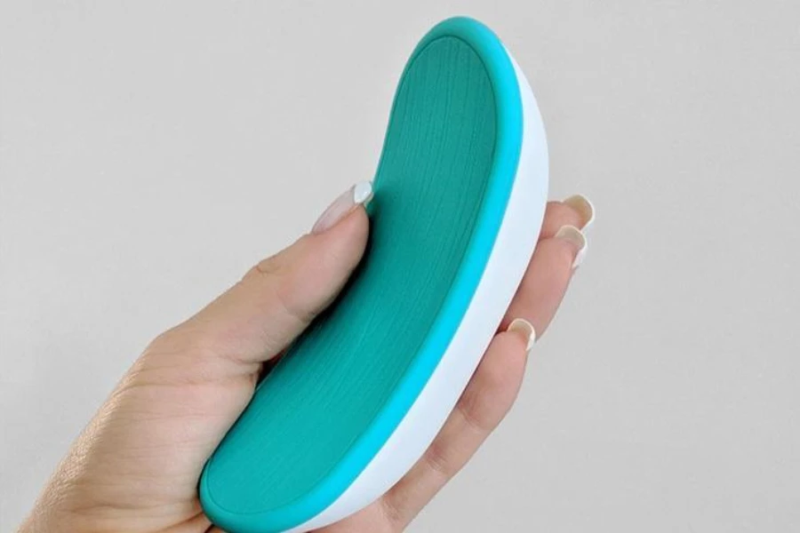 A woman holding a portable breast massager