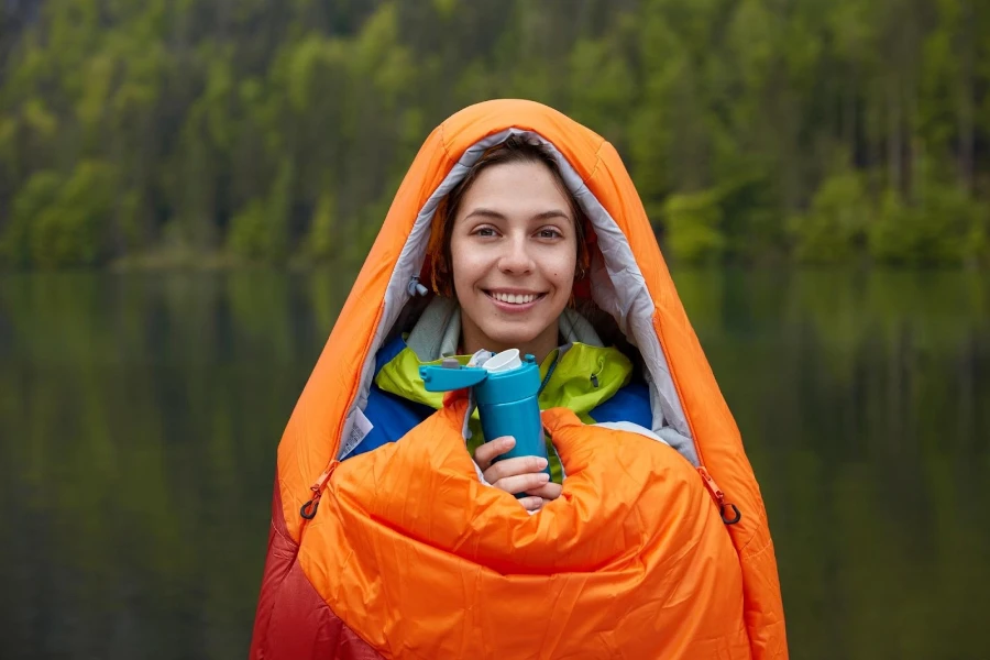 A woman in an all-season camping sleeping bag