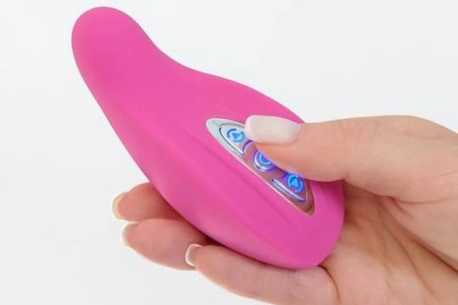 A woman operating a portable breast massager