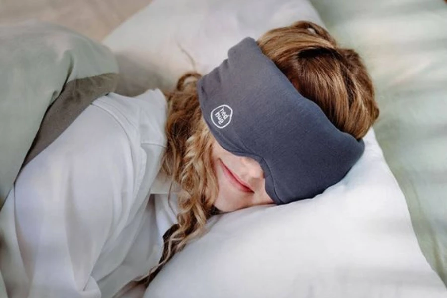 A woman sleeping in a weighted eye mask