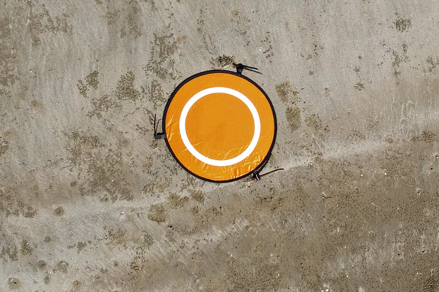 Aerial view of an orange landing pad on rock