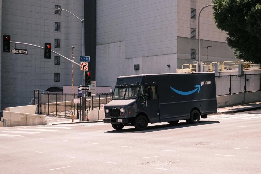 Amazon delivery van parked near white building during daytime