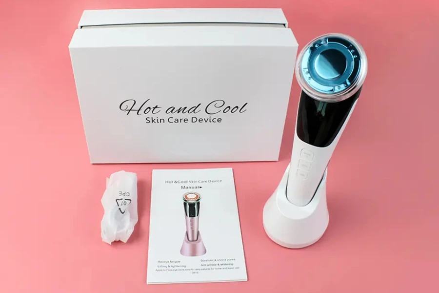 An electric ice globe massager on a pink background