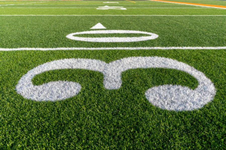 Artificial grass painted with lines for American football field