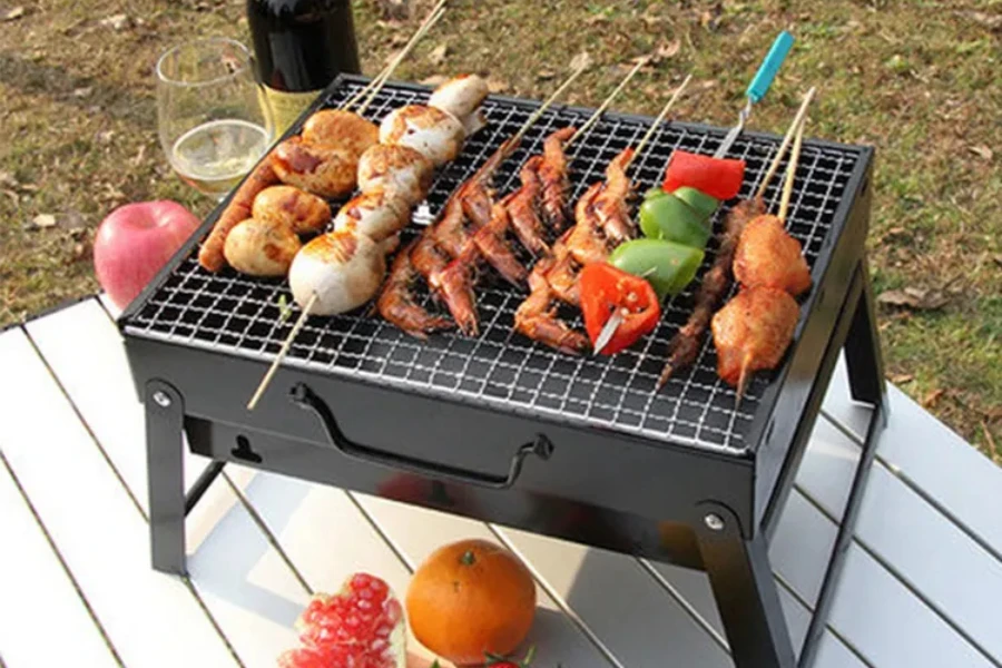 black portable electric grill being used to grill various food