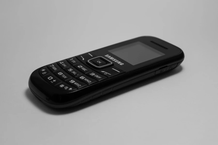 Black Samsung candybar phone against gray background