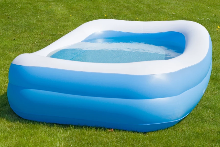 Blue and white rectangular inflatable pool filled with water