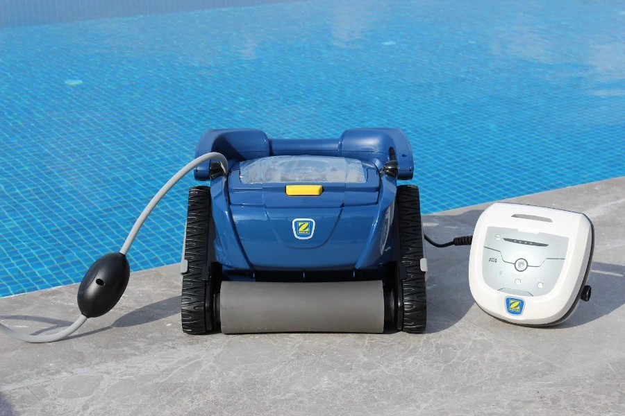 Blue robotic cleaner beside a pool