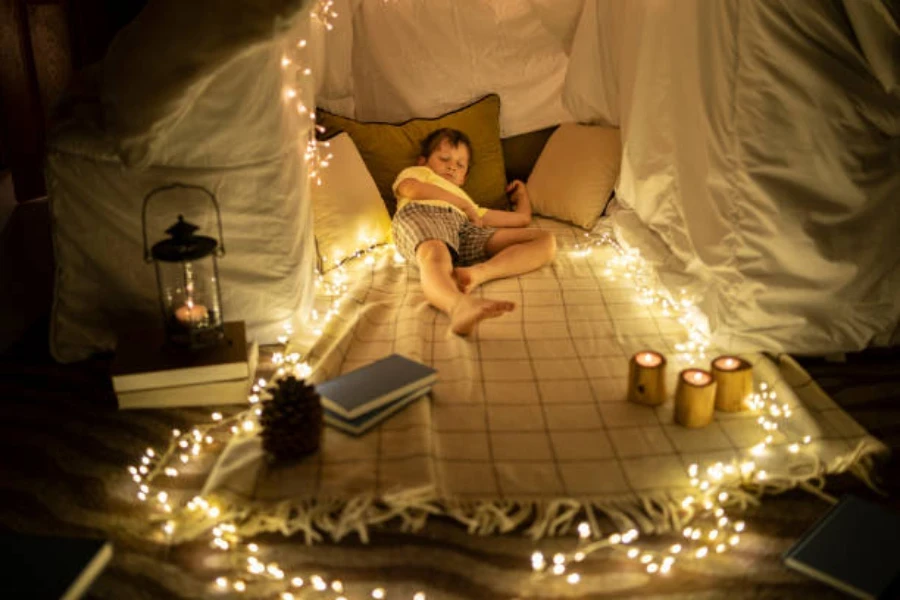 Boy lying down in tent with LED tent lights