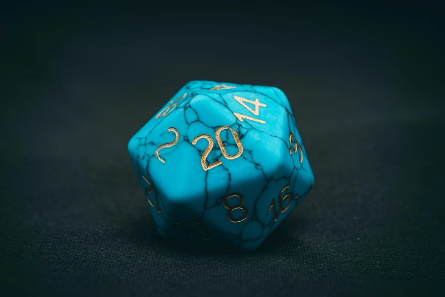 Bright blue D20 die with gold painted numbers