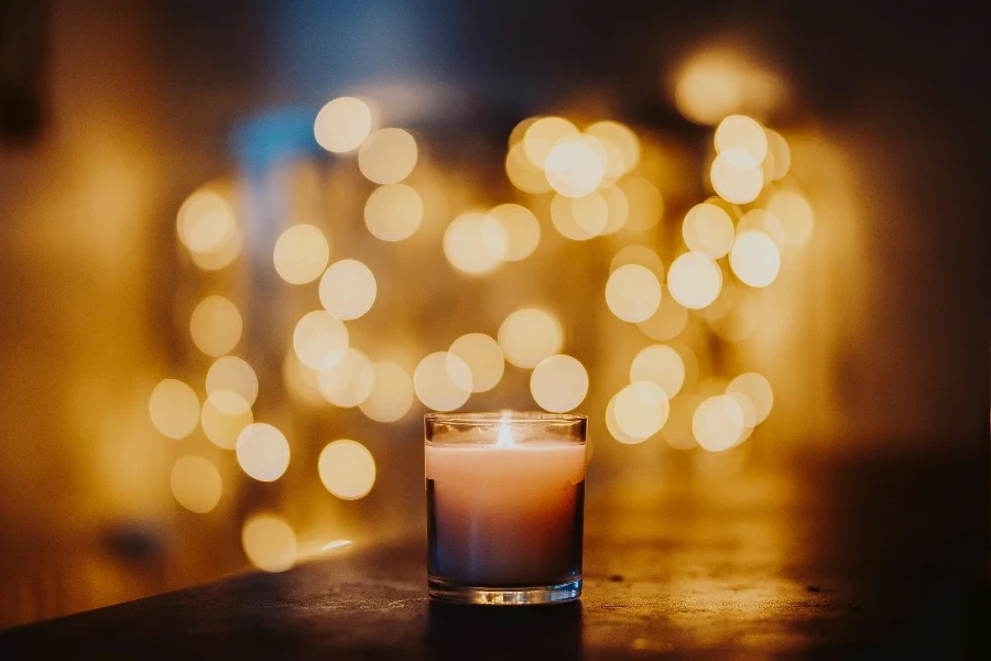 Burning candle in a glass jar